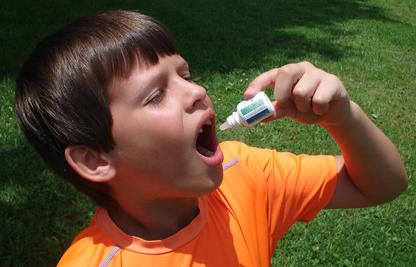 boy outside taking allergiDrops